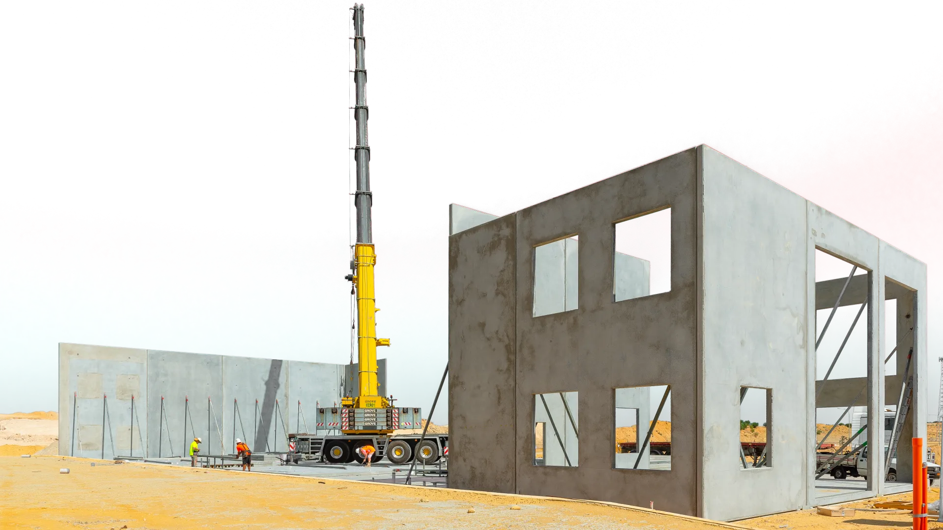 JD Rigging & Construction, Equipment Hire Australia crane sitting next to a concrete structure that it has built